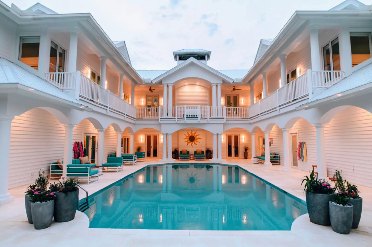 Sea Oats Luxury Estate in Captiva Island featuring a private courtyard pool surrounded by white coastal architecture and covered balconies.