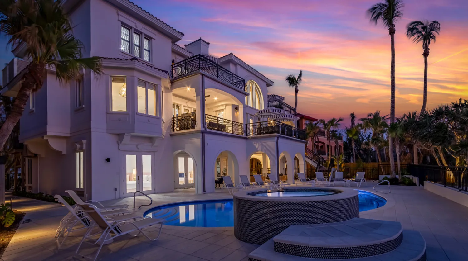 Sea Palms Luxury beachfront estate with resort-style pool and elevated terraces at sunset, featuring Mediterranean architecture and private outdoor lounging areas.